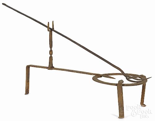Wrought iron trivet with tool rest, 19th c., 25'' l., together with a large meat fork, 33 1/2'' l.