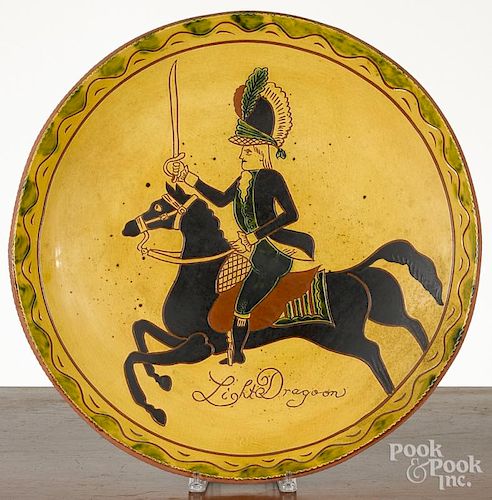 Massive Breininger redware charger decorated with a dragoon, 21 1/2'' dia.