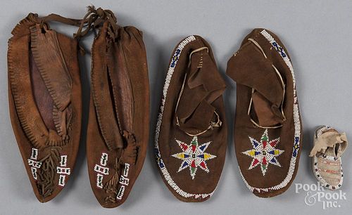 Two pairs of plains beaded moccasins, together with a single doll moccasin.