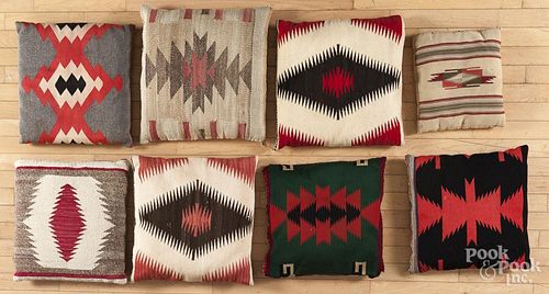 Eight Navajo weaving throw pillows.
