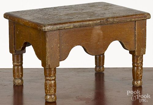 Painted walnut foot stool, 19th c., with a scalloped skirt