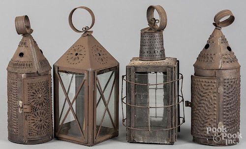 Four punched tin lanterns, 19th c., approximately 14'' h.