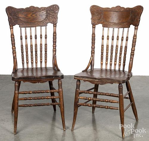 Pair of oak pressed back dining chairs, early 20th c.
