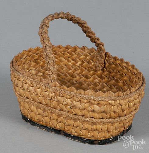 Miniature braided straw folk art basket with a wallpaper covered wooden base, 4 1/4'' h., 5 1/2'' l.