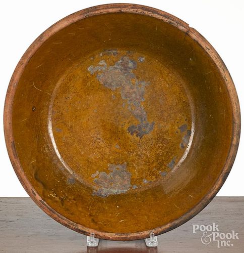 Large Pennsylvania redware shallow bowl, 19th c., 4'' h., 16 1/2'' dia.