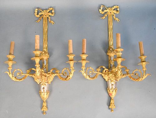 Pair of Gilt Bronze Sconces,having white brass bodies and heads with ram horns and female faces, electrified, height 30 inches.