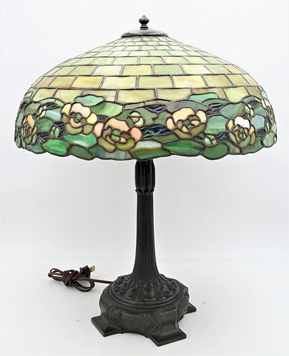 Attributed to Duffner and Kimberly Leaded Glass Table Lamp, having water lily band around bottom edge on bronze base, shade diameter 20 inches, height