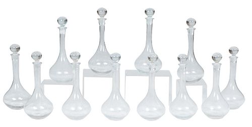 Set of Twelve Glass Bottle Form Decanters with Ball Stoppers, 20th c., Tallest- H.-14 in., Dia.- 6 in. (12 Pcs.)