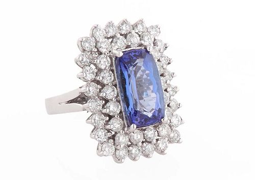 Lady's 14K White Gold Dinner Ring, with a 4.6 ct. rectangular cushion cut tanzanite atop conforming double graduated concentric borders of round diamo