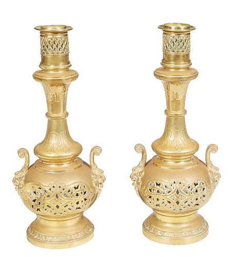 Pair of French Gilt Bronze Oil Lamps, 19th c., the everted neck over an incised socle to a pierced baluster base with two lions' head attached handles