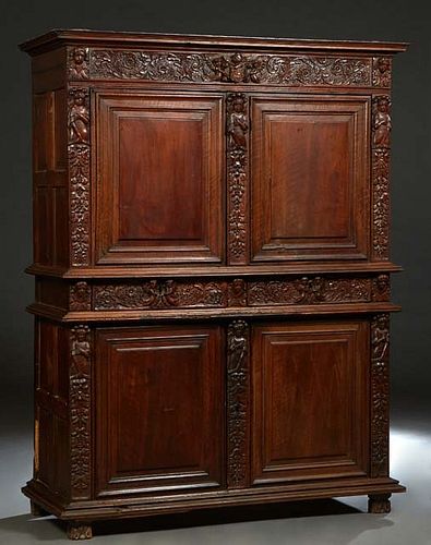 French Henri II Carved Walnut Buffet a Deux Corps, c. 1880, the stepped crown over a figural and floral carved frieze above double fielded panel cupbo
