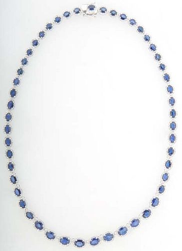 14K White Gold Link Necklace, each of the fifty-one oval links with a graduated oval blue sapphire atop a border of round diamonds, total sapphire wt.