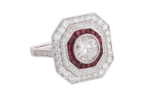 Lady's 18K White Gold Dinner Ring, with a central 1.50 carat round diamond within an octagonal border of baguette rubies, within two concentric octago