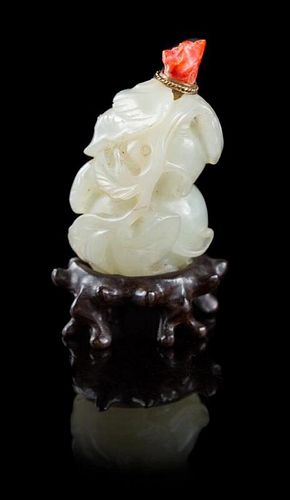 * A Carved Pale Celadon Jade Snuff Bottle Height 2 1/2 inches.