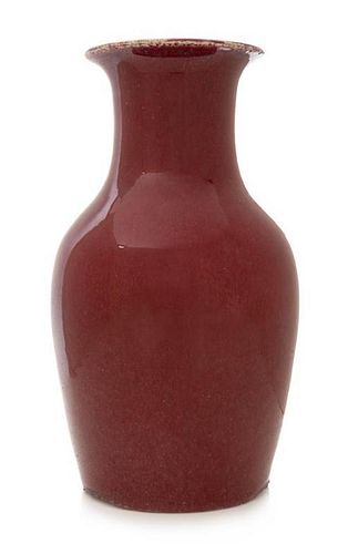 * A Sang-de-Boeuf Glazed Porcelain Vase Height 14 inches.