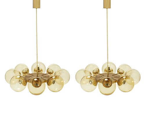 A pair of mid-century modern brass globe chandeliers