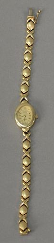14K gold ladies wristwatch with 14K gold band. 
lg. 7 in.; 18.6 grams total weight