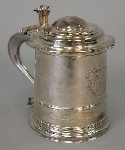 Important silver tankard having rounded top with scroll thumb support on plain body with large scrolled handle, front with coat of a...