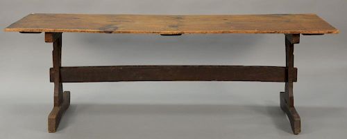 Primitive tressel foot table having pine single board top on oak tressel base. 
ht. 30 in.; top: 30 1/2" x 90"