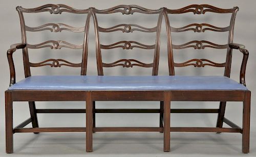 Custom mahogany triple chair back settee, Chippendale style with ladder backs and slip leather upholstered seat set on square tapere...