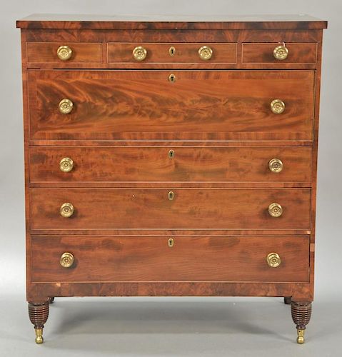 Sheraton mahogany chest with three short drawers over four long drawers all set on turned legs ending in brass capped feet. 
ht. 52 ...