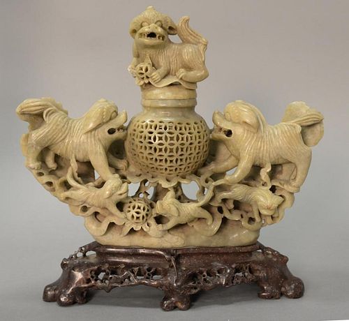 Large Chinese carved soapstone foodog sensor having foodog finial over cylindrical reticulated carved sensor surrounded by five food...