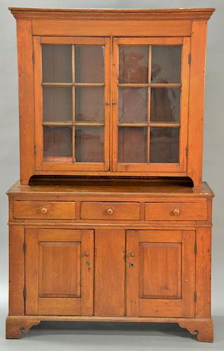 Chippendale stepback cupboard in two parts, upper portion having cornice molded top over two glazed doors on lower portion with thre...