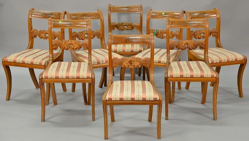 Set of eight federal mahogany side chairs having oak leaf and nut carved backs over slip seats on sabre legs, circa 1830-1840 (one c...