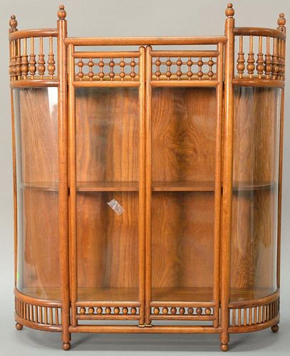 Oak stick and ball bowed glass hanging curio cabinet. 
ht. 32 in.; wd. 26 1/2 in.