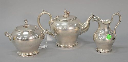 American silver three piece tea set with acorn and oak leaf finials and beadwork with scroll handles, marked Jones & Ball Co. Boston...