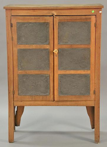 Primitive pie safe having two doors, each with three pierce tin panels, all on plain square legs. 
ht. 57 in.; wd. 38 in.; dp. 15 1/...
