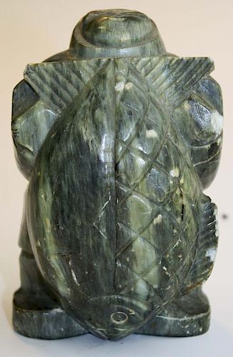 Inuit soapstone carving of a hunter w/ a large fish signed Kaxuitak, slight damage, wear to high spo