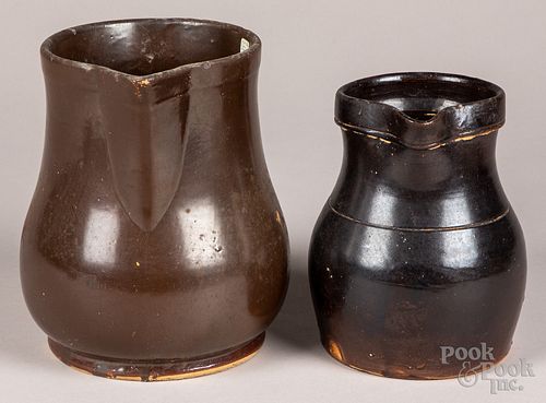 Two Albany slip stoneware pitchers, late 19th c.