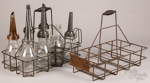 Group of oil bottles with rack, to include a Moore