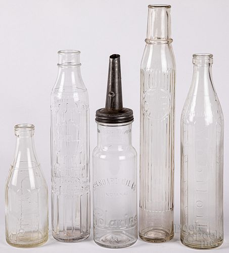 Five glass oil bottles, to include Polarine, quart