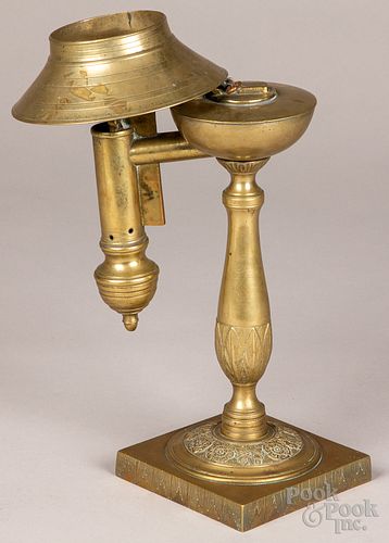 Unusual brass oil lamp with hinged brass shade
