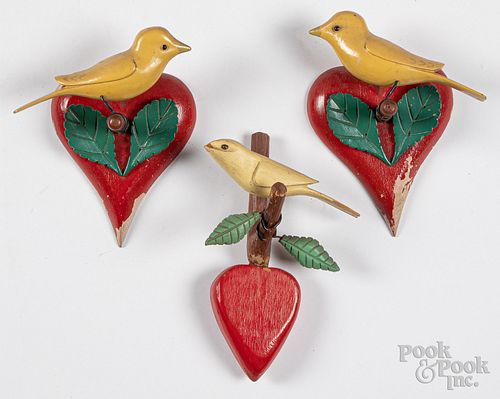 Pair of carved and painted birds on heart plaques