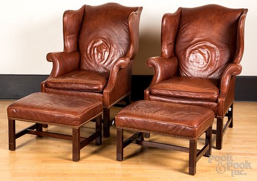 Pair of leather upholstered wing chairs & ottoman