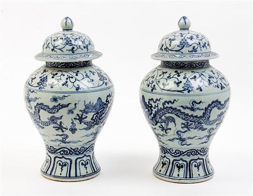 * A Pair of Blue and White Porcelain Jars and Covers Height 14 inches.