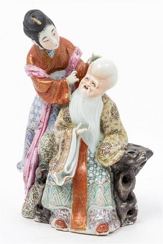 * A Chinese Famille Rose Porcelain Figural Group Height 9 inches.