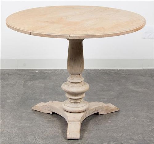 * A Neoclassical Bleached Wood Center Table Height 28 3/4 x diameter 35 inches.