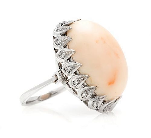 An 18 Karat White Gold, Coral and Diamond Ring, 10.50 dwts.