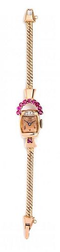 A Retro 14 Karat Rose Gold, Ruby and Diamond Wristwatch, Lucien Picard, Circa 1940, 10.90 dwts.