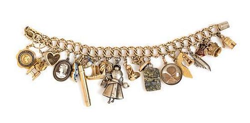 * A 14 Karat Yellow Gold Charm Bracelet with 20 Attached Charms, 60.80 dwts