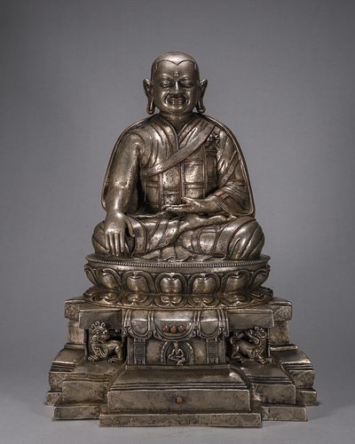 A silver-inlaid copper Tibetan buddha statue
