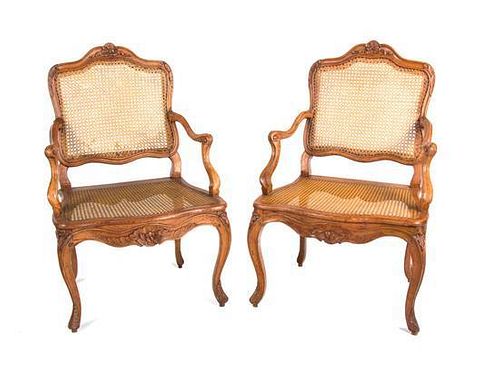 A Pair of Louis XV Style Walnut Fauteuils Height 38 3/4 inches.