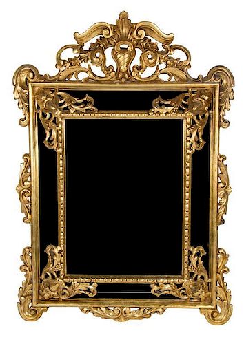 A Louis XIV Style Carved Giltwood Mirror 64 3/4 x 46 1/4 inches.