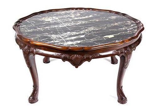An English Mahogany Low Coffee Table Height 19 x diameter 38 inches.