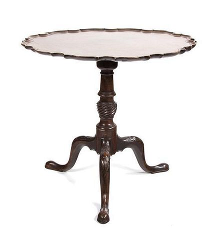 A Chippendale Style Mahogany Tilt Top Table Height 29 1/2 x diameter 29 3/4 inches.