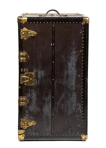 A Brass Mounted Black Steamer Trunk Height 25 x width 39 x depth 22 inches.